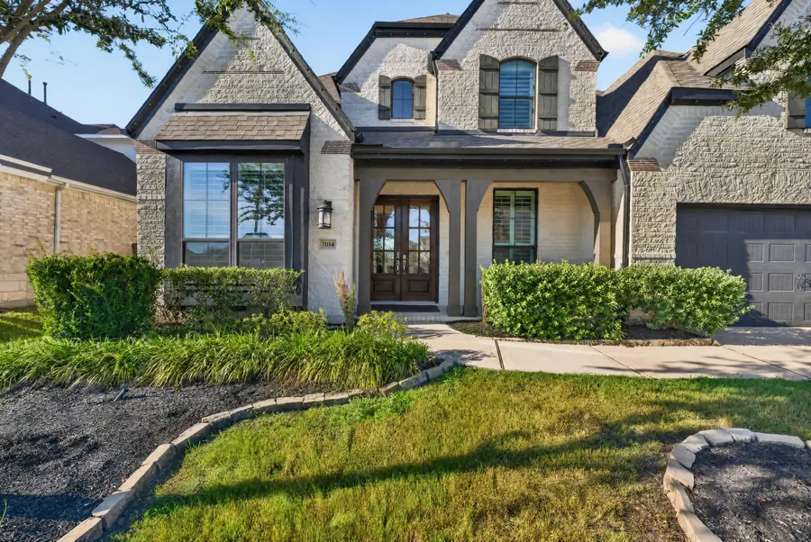 Front exterior of a stone and brick home