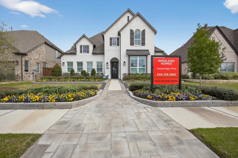 Model home exterior with landscaped walkway