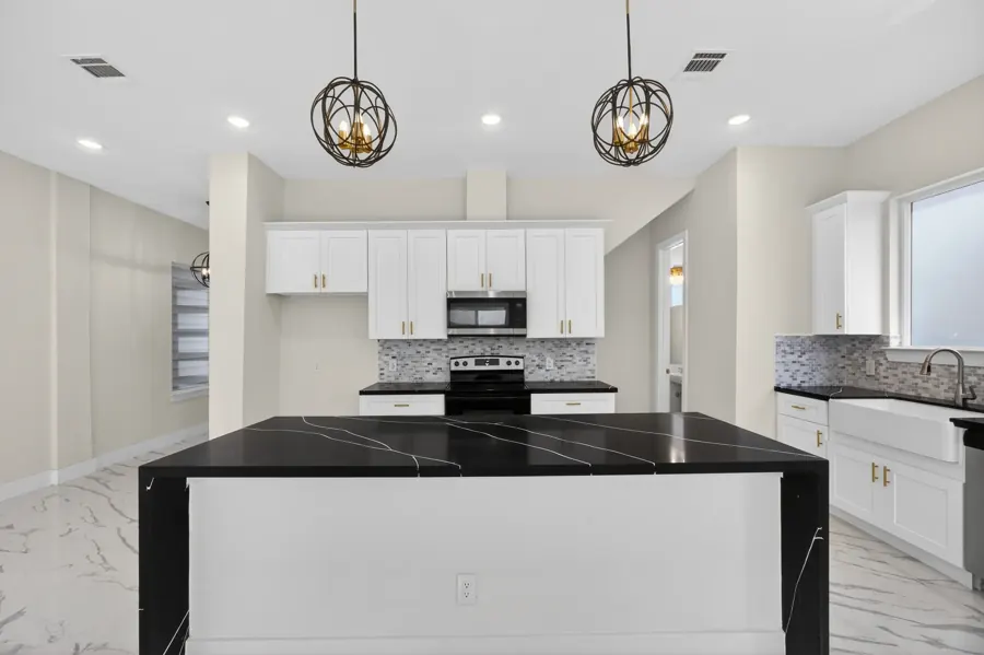 Kitchen with black waterfall island